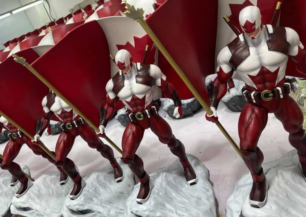 A row of Captain Canuck statues on a production table in 1/6 scale sculpted in polystone