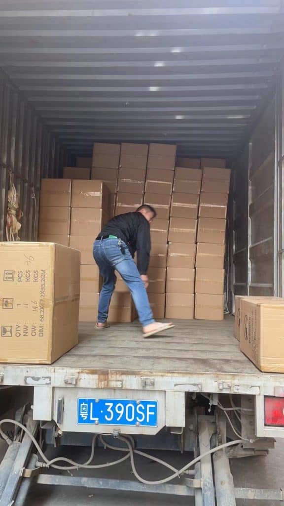 boxes of bedrock collectibles statues stacked in truck