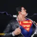 Superman Clark Kent transformation 1/4 Scale statue close up left with large S symbol and dress shirt and tie blowing in wind. Secret Origins 1/4 scale statue by Bedrock Collectibles